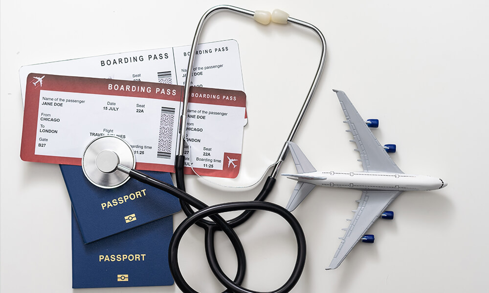 bilety lotnicze, stetoskop - akcesoria podróżniczne na stole